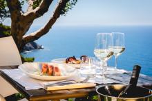 Outdoor dining setup with wine and seafood.